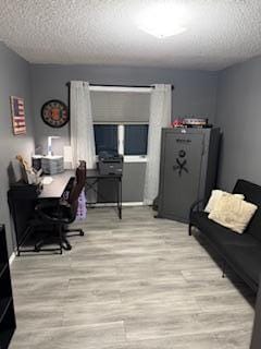 1415 Trailwood Ln SW, Faribault, MN 55021 - home office featuring a textured ceiling and wood finished floors