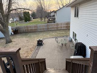 1415 Trailwood Ln SW, Faribault, MN 55021 - fenced backyard featuring a deck