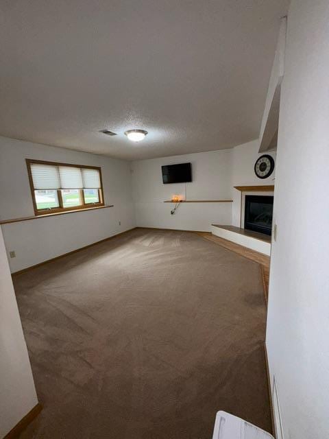 1415 Trailwood Ln SW, Faribault, MN 55021 - unfurnished living room with carpet floors and a fireplace with raised hearth
