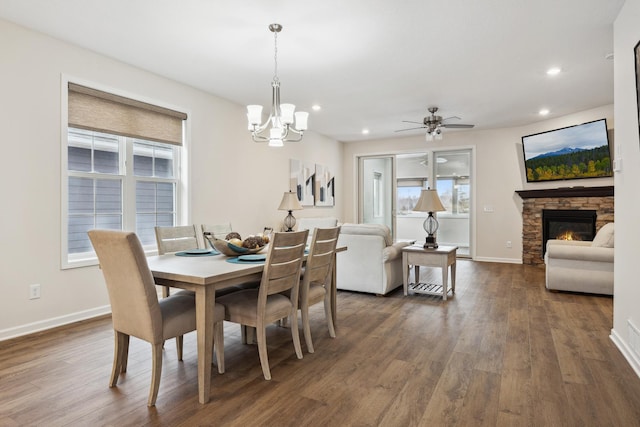 17865 Graphite Ln, Lakeville, MN 55044 - dining room featuring dark wood-style floors, plenty of natural light, recessed lighting, ceiling fan with notable chandelier, and a fireplace