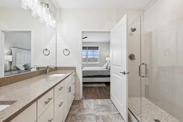 17865 Graphite Ln, Lakeville, MN 55044 - ensuite bathroom featuring double vanity, ensuite bath, a stall shower, and a sink