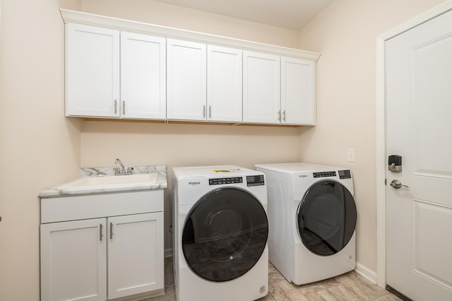 17865 Graphite Ln, Lakeville, MN 55044 - laundry area with cabinet space, washing machine and clothes dryer, baseboards, and a sink