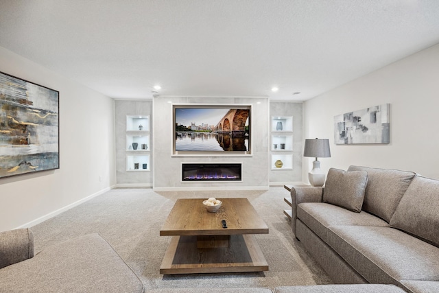 17865 Graphite Ln, Lakeville, MN 55044 - carpeted living room featuring a glass covered fireplace, baseboards, recessed lighting, and built in shelves