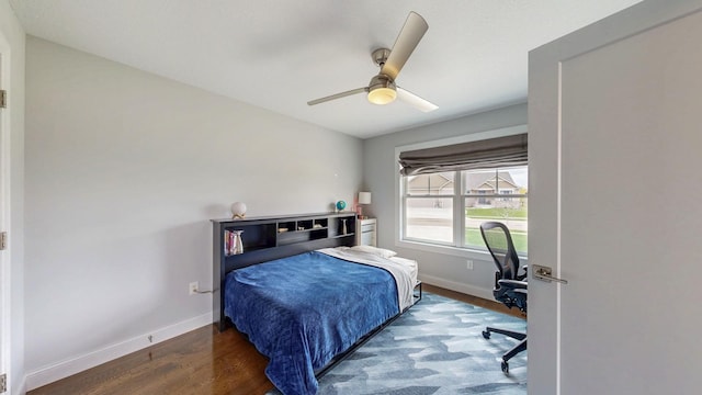 bedroom featuring baseboards, ceiling fan, and wood finished floors