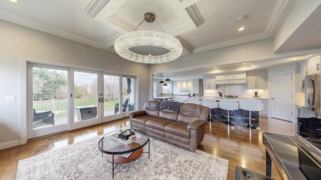 living room with french doors, wood finished floors, ornamental molding, coffered ceiling, and recessed lighting