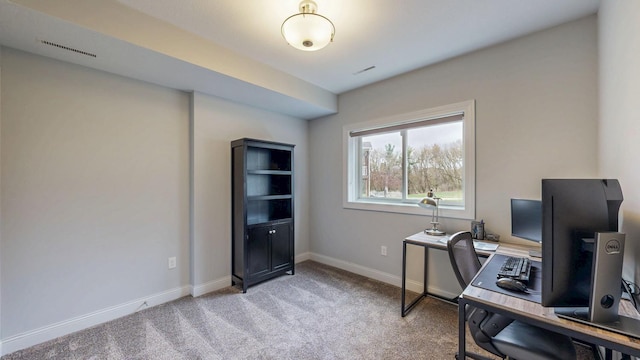 home office with baseboards, light carpet, and visible vents