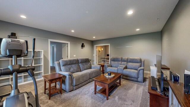 carpeted living room with recessed lighting and baseboards