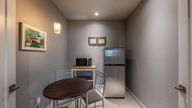 dining space with baseboards and recessed lighting