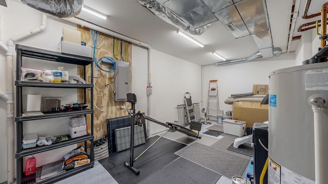 workout area featuring electric panel and gas water heater