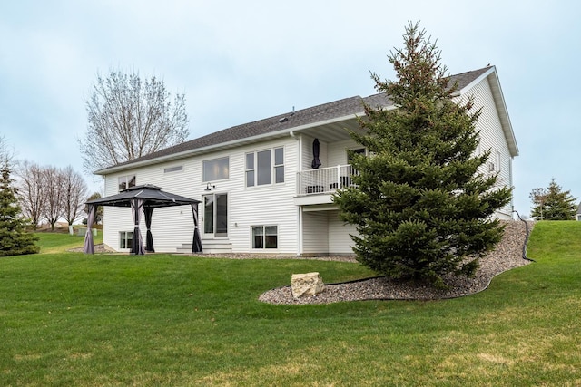 back of property with a lawn and a gazebo