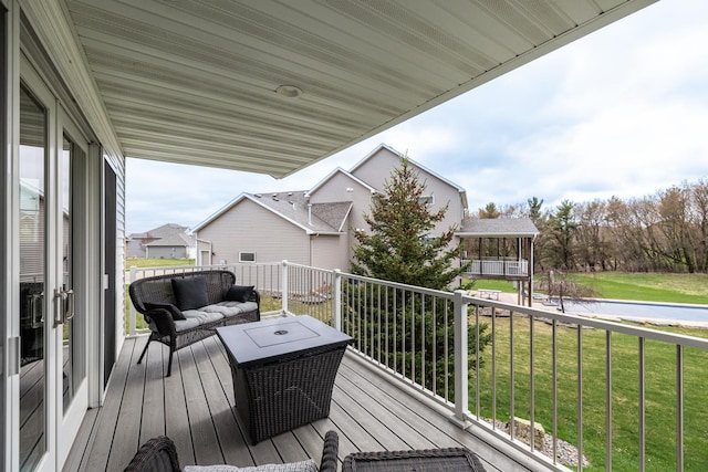 wooden terrace featuring a yard