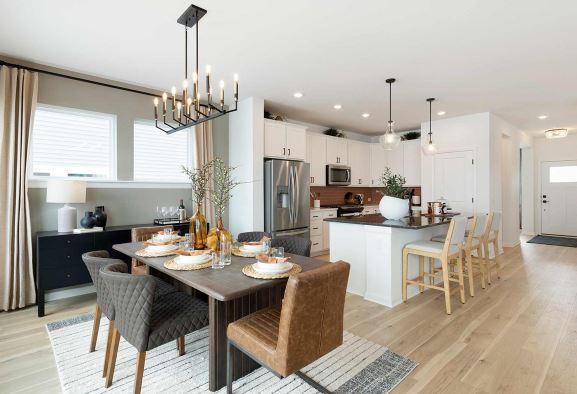dining area with a chandelier, light wood-style floors, and recessed lighting