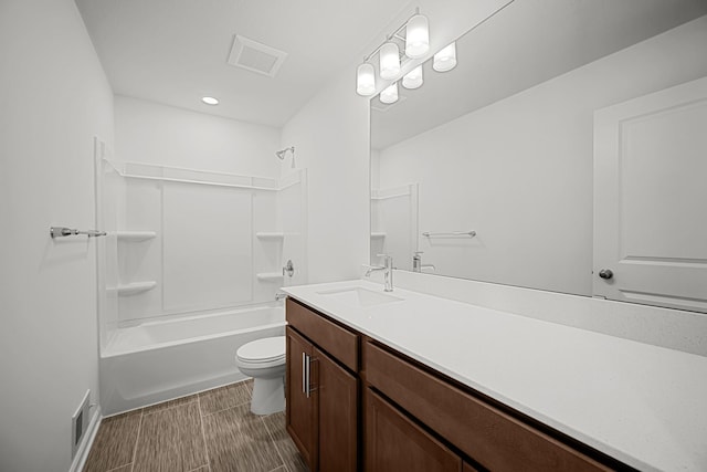 bathroom with bathtub / shower combination, vanity, visible vents, and toilet