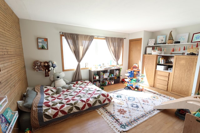 101 Mckenzie Ave, Strathcona, MN 56759 - bedroom featuring wood finished floors and wood walls