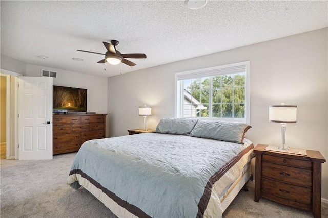 bedroom featuring visible vents, a ceiling fan, a textured ceiling, and carpet flooring
