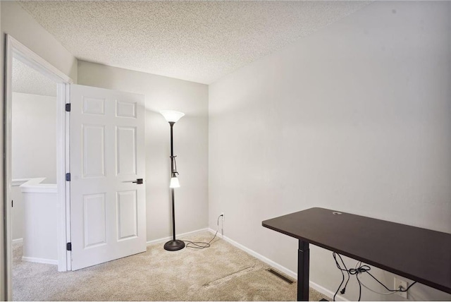 interior space featuring a textured ceiling, visible vents, and carpet floors