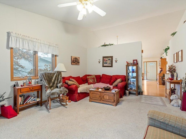 living room featuring lofted ceiling, carpet floors, and a ceiling fan
