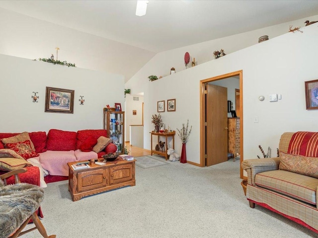 living area featuring vaulted ceiling and carpet flooring