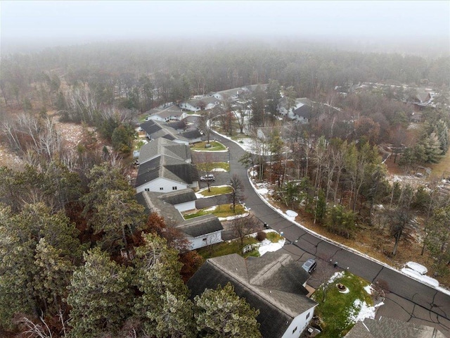 aerial view featuring a residential view and a wooded view