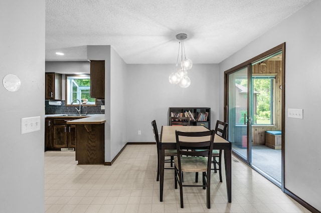 805 Ithaca Ln N, Plymouth, MN 55447 - dining area with a textured ceiling and baseboards