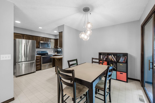 805 Ithaca Ln N, Plymouth, MN 55447 - dining room featuring baseboards, a textured ceiling, and recessed lighting