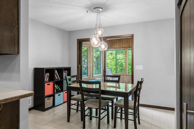 805 Ithaca Ln N, Plymouth, MN 55447 - dining space with a textured ceiling and baseboards