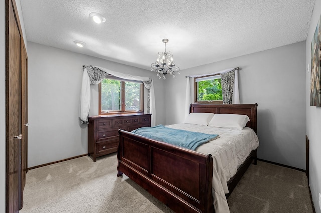 805 Ithaca Ln N, Plymouth, MN 55447 - bedroom with light carpet, multiple windows, a textured ceiling, a chandelier, and baseboards