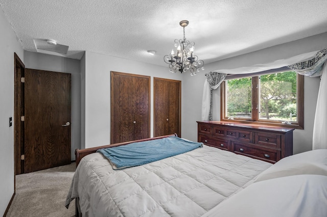 805 Ithaca Ln N, Plymouth, MN 55447 - bedroom with carpet floors, a textured ceiling, and a chandelier