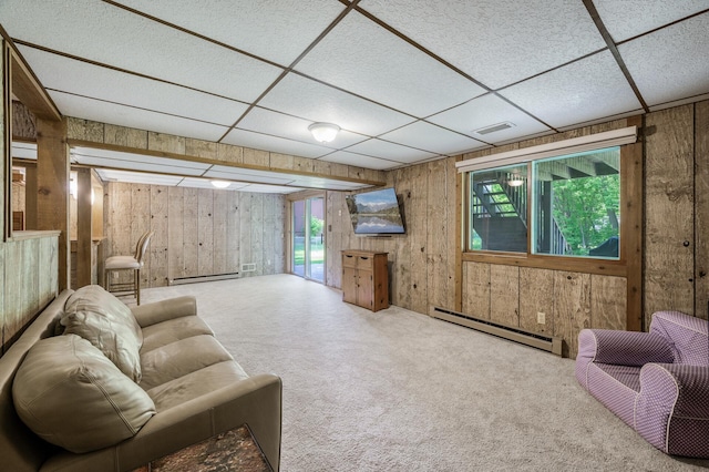 805 Ithaca Ln N, Plymouth, MN 55447 - carpeted living area featuring a baseboard radiator, wooden walls, plenty of natural light, a baseboard heating unit, and a drop ceiling