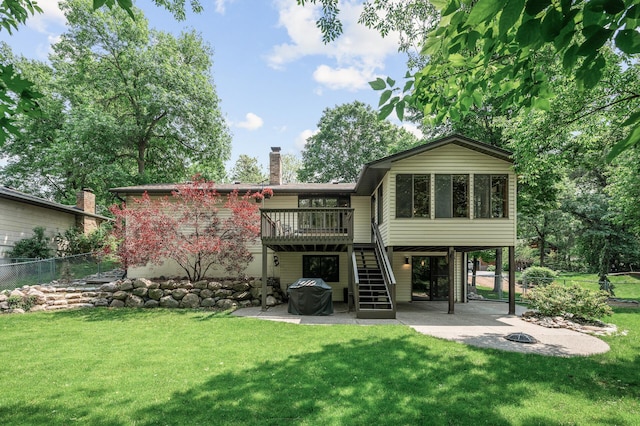 805 Ithaca Ln N, Plymouth, MN 55447 - back of property featuring a patio area, a chimney, a wooden deck, a sunroom, and a carport