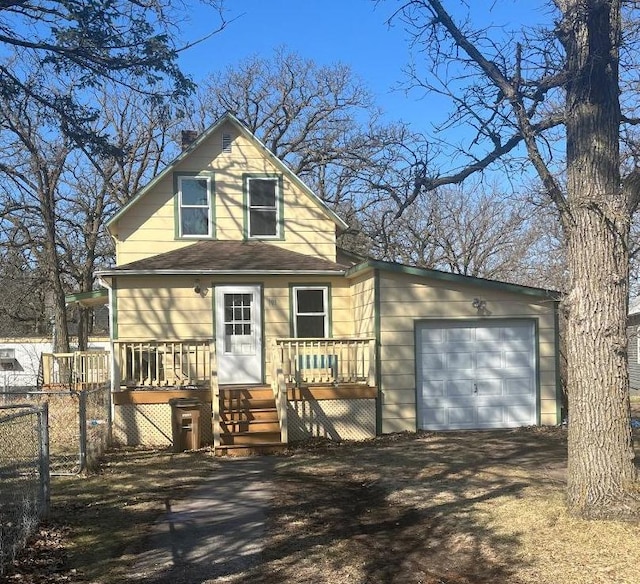 view of front facade featuring a garage, a wooden deck, and fence