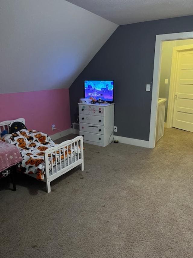 bedroom featuring lofted ceiling, carpet flooring, and baseboards
