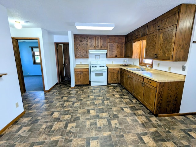 46167 Jefferson Lake Dr, Cleveland Twp, MN 56017 - kitchen featuring a sink, baseboards, light countertops, white range with gas cooktop, and under cabinet range hood
