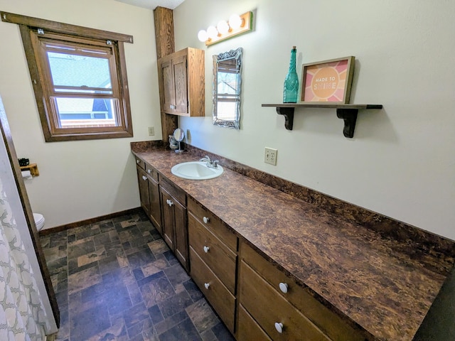 46167 Jefferson Lake Dr, Cleveland Twp, MN 56017 - bathroom with stone finish floor, plenty of natural light, baseboards, and vanity