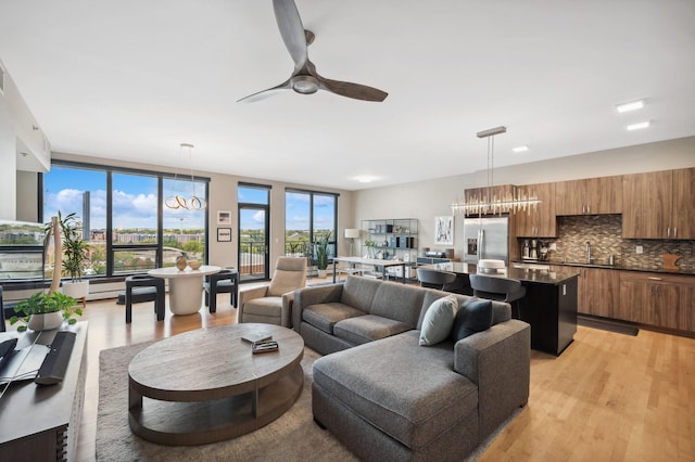 1240 2nd St Unit 526, Minneapolis, MN 55415 - living room featuring light wood-style flooring and ceiling fan with notable chandelier