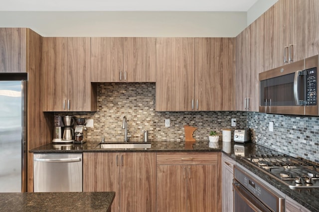 1240 2nd St Unit 526, Minneapolis, MN 55415 - kitchen with dark stone countertops, decorative backsplash, appliances with stainless steel finishes, a sink, and modern cabinets