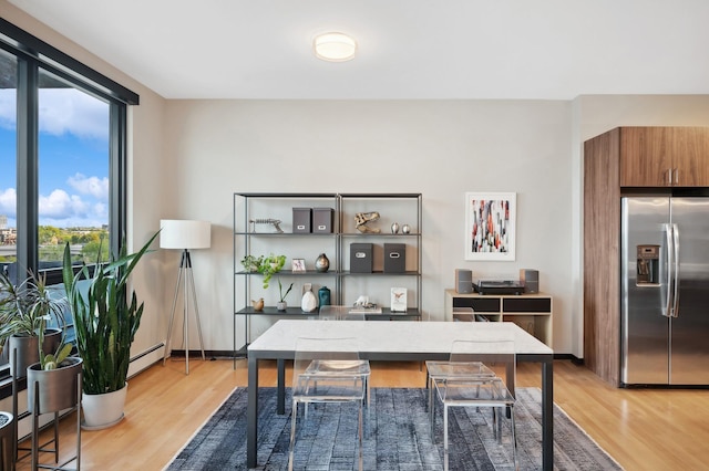 1240 2nd St Unit 526, Minneapolis, MN 55415 - office with light wood finished floors, baseboards, and a baseboard radiator