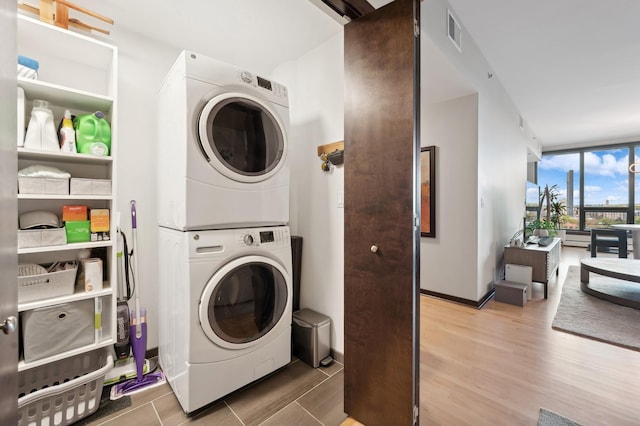 1240 2nd St Unit 526, Minneapolis, MN 55415 - washroom with visible vents, wood finished floors, stacked washer / drying machine, and laundry area