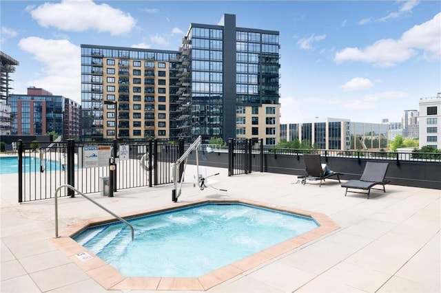 1240 2nd St Unit 526, Minneapolis, MN 55415 - pool featuring a patio, a view of city, and fence