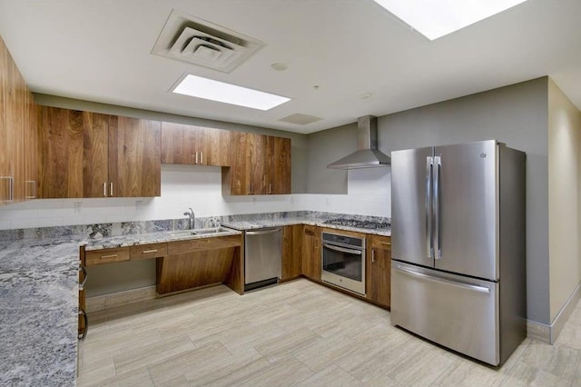 1240 2nd St Unit 526, Minneapolis, MN 55415 - kitchen featuring visible vents, brown cabinetry, stainless steel appliances, and wall chimney range hood
