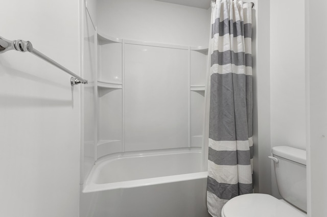 bathroom featuring shower / tub combo with curtain and toilet