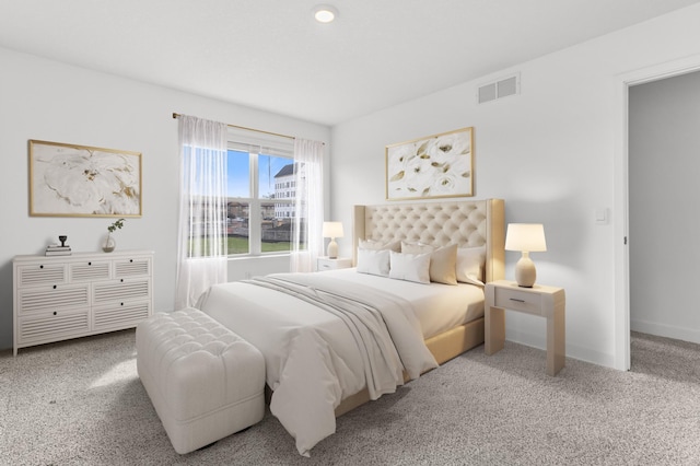 carpeted bedroom featuring baseboards and visible vents