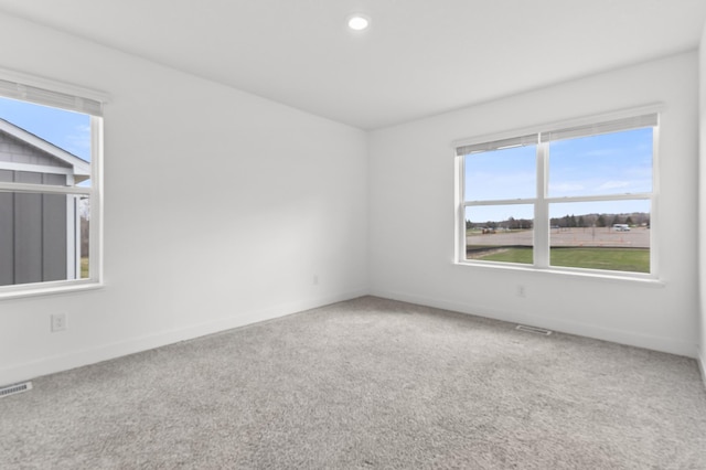 empty room with baseboards, carpet flooring, visible vents, and recessed lighting