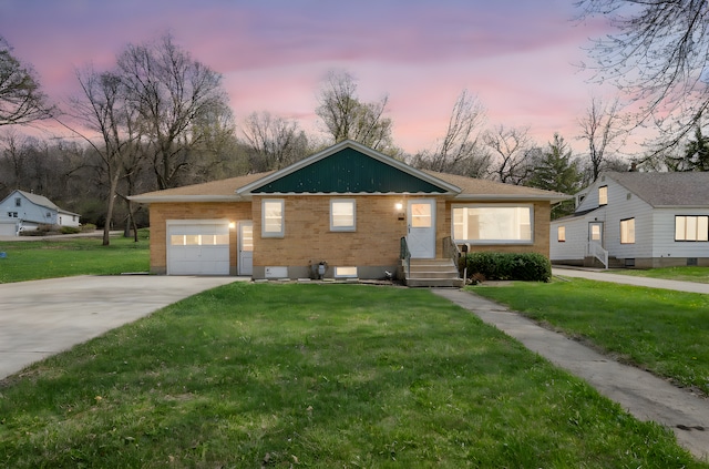 ranch-style home with a garage, a front lawn, and brick siding