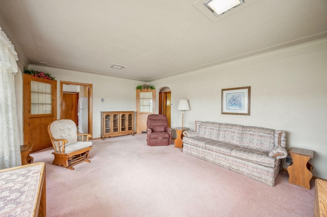 carpeted living room with arched walkways