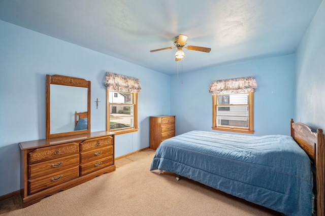 bedroom featuring baseboards, a ceiling fan, and light colored carpet