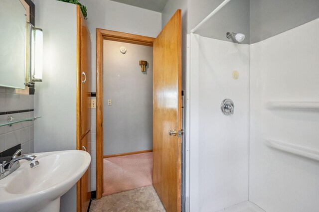 bathroom with a sink and walk in shower