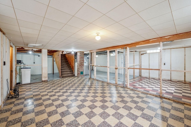 finished below grade area with stairway and tile patterned floors