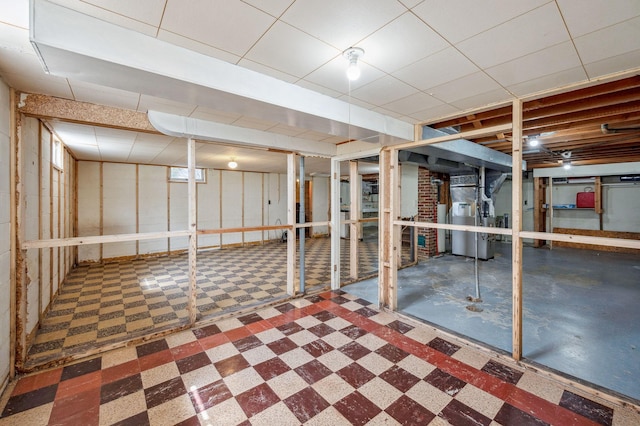 below grade area featuring heating unit and tile patterned floors