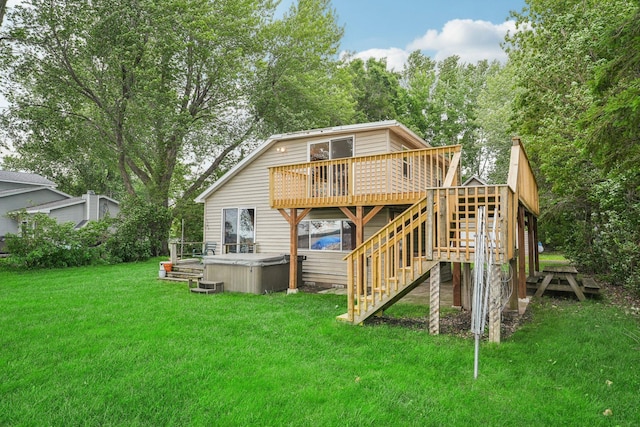 back of house with a yard, a wooden deck, a hot tub, and stairway